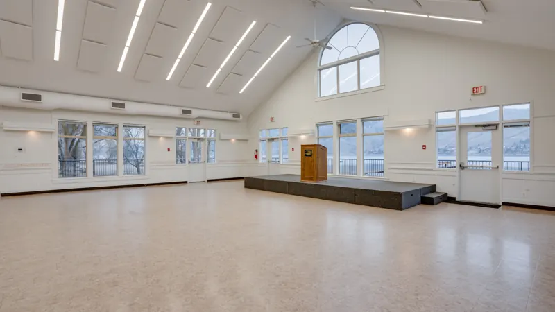 Paddlewheel Hall main room with vaulted ceiling and lake-facing windows